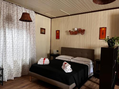 a bedroom with a bed with towels on it at B&B Camelia in Camugnano