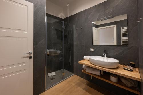 a bathroom with a sink and a shower at Le Absidi luxury rooms and suites in Sciacca