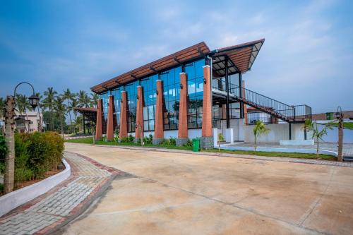 a large building with a staircase in front of it at Serene Resort Hyderabad in Shamshabad