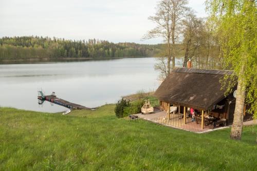 a helicopter is parked next to a lake at Viesu nams ''Laukezers'' in Vilciņi