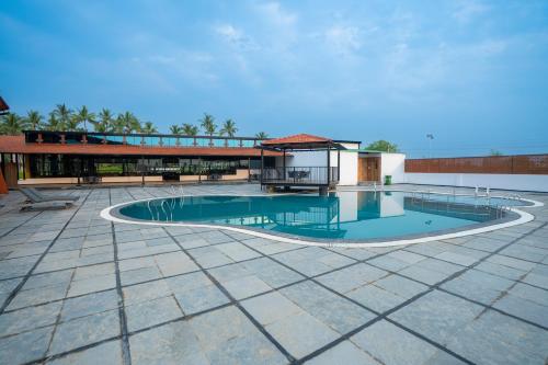 a swimming pool on top of a building at Serene Resort Hyderabad in Shamshabad