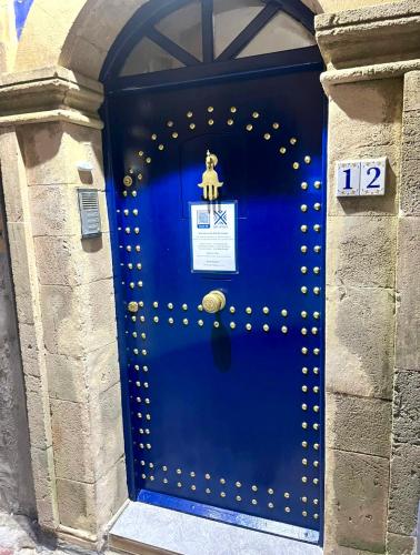 a blue door with a sign on it at Riad Dar Latigeo in Essaouira