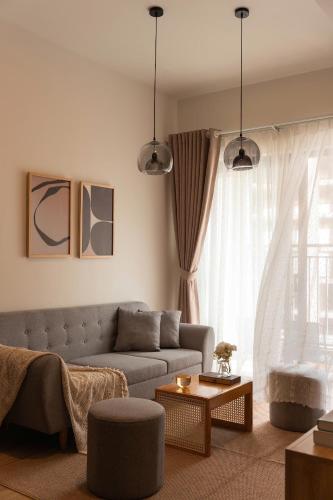a living room with a couch and a table at Otis Soho Saigon Balcony Apartment in Ho Chi Minh City
