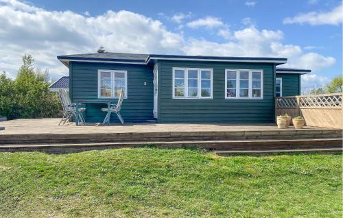a blue tiny house with a porch and a deck at Holiday Home Børkop With Sea View Vi in Børkop