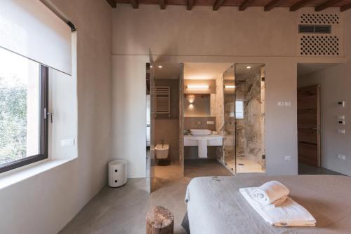 a bathroom with a shower and a bed in a room at Torre di Baratti Bio Resort in Populonia
