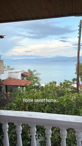 a view of the ocean from a balcony with the words home sweet home at Kiveri Traditional Villa in Kiveri