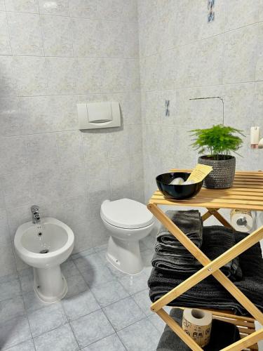 a bathroom with a toilet and a sink at house prua a step from the lake in Bellano