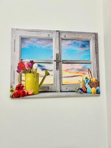 an open window with a vase of flowers and easter eggs at house prua a step from the lake in Bellano