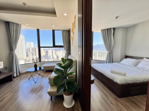 a hotel room with a bed and a large window at La Maison HUD building 2beds in Nha Trang