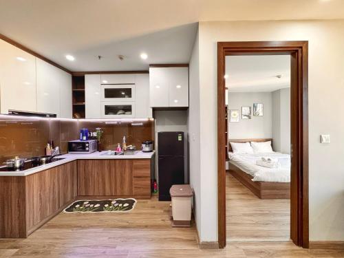 a kitchen with a sink and a bed in a room at La Maison HUD building 2beds in Nha Trang