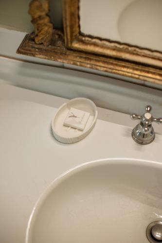 a bathroom sink with a soap dispenser on top of it at Classique in Lazise