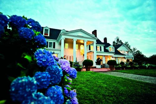 a house with blue flowers in front of it at Inn at Perry Cabin in Saint Michaels