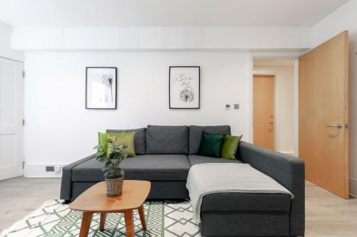 a living room with a couch and a table at Kensington Prime Apartments in London