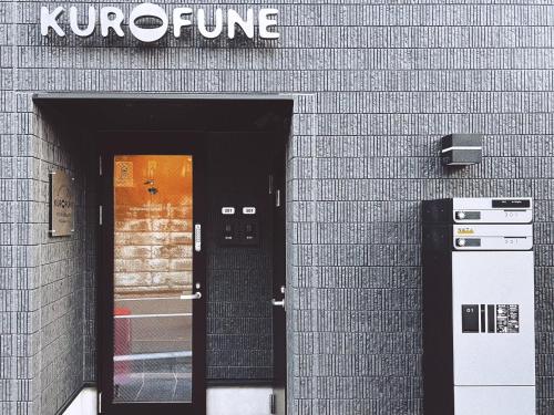 a door into a building with a sign on it at KUROFUNE久我山ハウス,shibuya 13min,Kichijoji3min in Kugayama