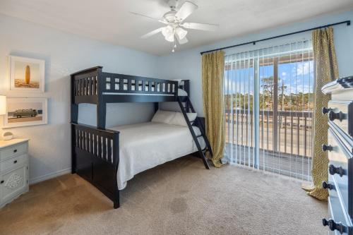 a bedroom with a bunk bed and a window at Kate's Place - 13554 Perdido Key Drive in Pensacola
