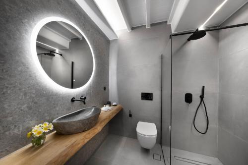 a bathroom with a sink and a mirror at Deliades Hotel in Ornos