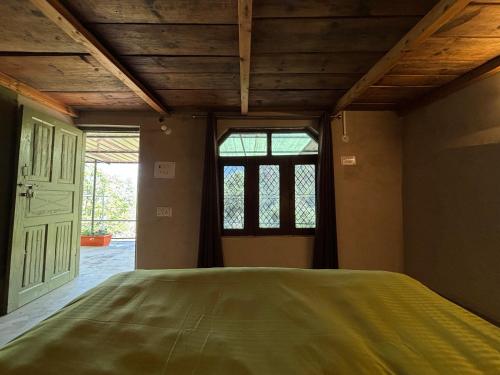 a large bed in a room with a window at #middleofnowehere Pahadi Homestay by Mon Stays in Dhanaulti