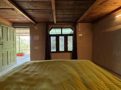 a large bed in a room with a window at #middleofnowehere Pahadi Homestay by Mon Stays in Dhanaulti