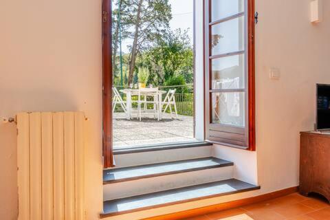 an open door to a patio with a table outside at Golf House - Valle Christi in Rapallo