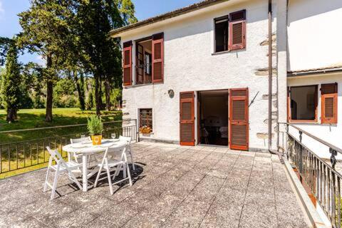 a patio with a table and chairs in front of a house at Golf House - Valle Christi in Rapallo