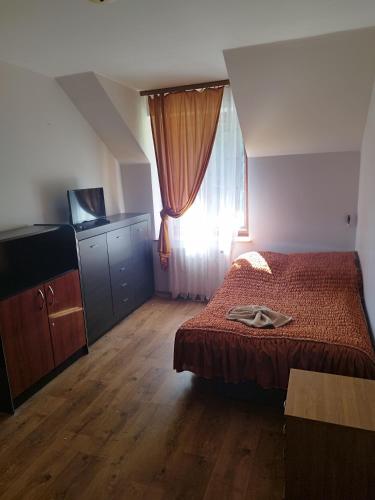 Postel nebo postele na pokoji v ubytování Wilcza łapa