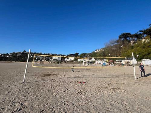 a group of people playing soccer on the beach at Lovely family house near the sea for 8 in Plestin-les-Grèves