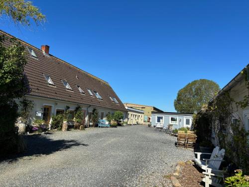 a street in a village with houses and chairs at Strandhof Holnis in Glücksburg