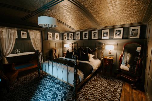 a bedroom with a bed and a sink in it at Sheddington Manor - 2 Bedroom Guest House & Cinema in Belfast