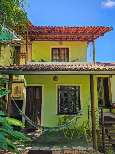 a green and yellow house with a red roof at Canto Verde Pousada in Lençóis