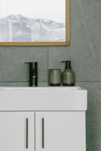 a white cabinet with three pots on top of it at Harmony Seljalandsfoss in Hvolsvöllur