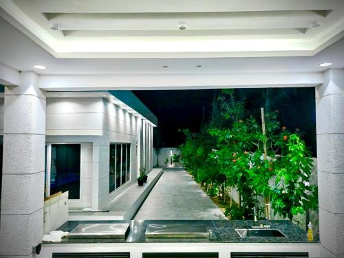 a view of a hallway of a building with plants at Radiance Holiday Resort Muscat in Seeb