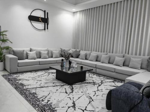 a living room with a couch and a coffee table at Radiance Holiday Resort Muscat in Seeb