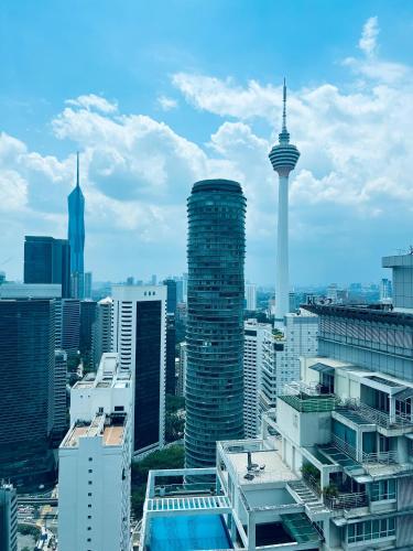 a view of a city skyline with the space needle at Sky Suites KLCC by Luna KL in Kuala Lumpur