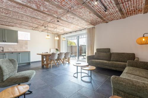 a living room with a couch and chairs and a table at Huyze Basco in Poperinge