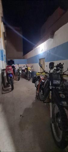a group of motorcycles parked in a garage at Maison Halimos in Midelt