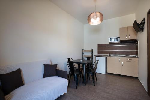 a living room with a table and a couch at Asimenis Cottages in Kattavía
