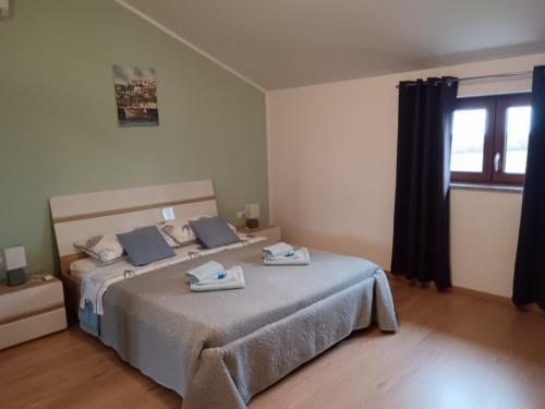 a bedroom with a large bed with blue towels on it at Apartment Petar in Begi in Vrsar