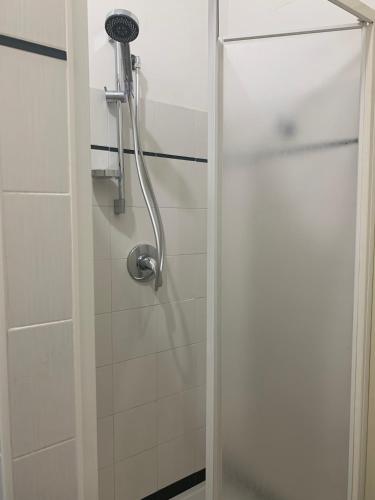 a shower with a glass door in a bathroom at Dove il tramonto incontra il mare, attico panoramico a due passi dalla spiaggia in Minturno