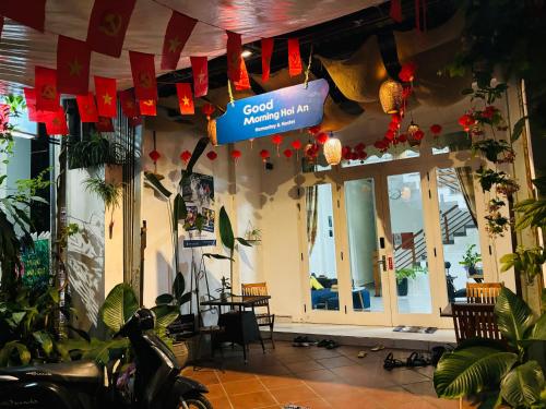 a restaurant with a sign hanging from the ceiling at Good Morning Hoi An Homestay and Hostel in Hoi An