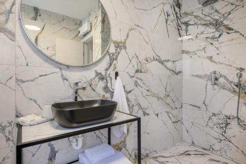 a bathroom with a sink and a mirror at Apartments Penthouse lux XYZ in Rogoznica