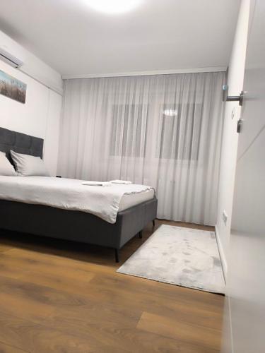 a bedroom with a bed and a window at Luxury apartments Sarajevo-free parking in Sarajevo