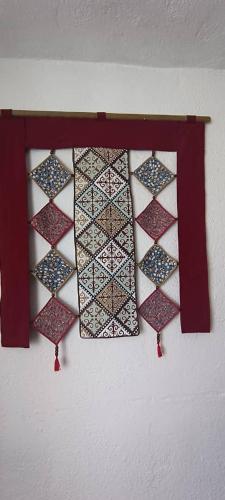 a group of ties hanging on a wall at "Martin" guest house in Kara-Talaa