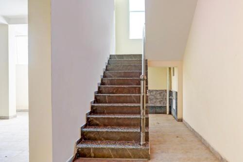 a stairway in a building with a stair case at Hotel O Zoo Palace in Nagpur