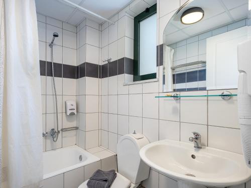 a bathroom with a toilet and a sink at Kambos Village in Agia Marina Nea Kydonias