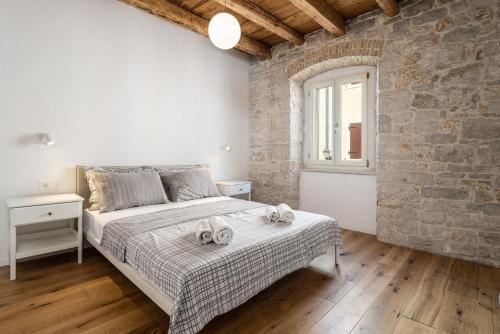 Ένα ή περισσότερα κρεβάτια σε δωμάτιο στο Apartments Eliza