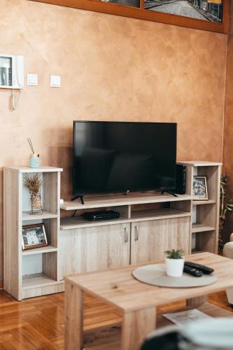 a living room with a flat screen tv on a entertainment center at Bella Apartmani in Valjevo