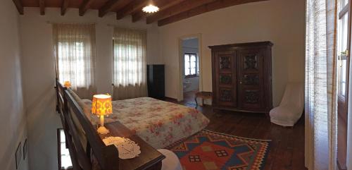 a bedroom with a bed and a table with a lamp at Cascina Delle Rose in Barbaresco