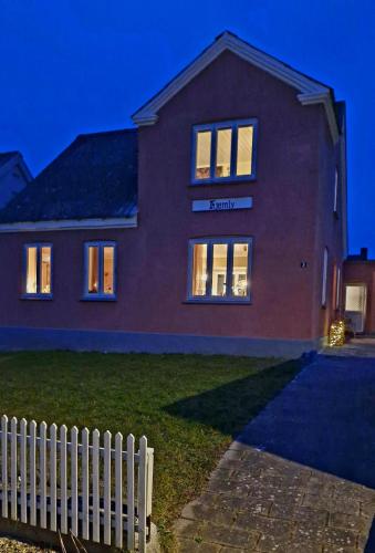 a house with a white fence in front of it at Beautiful and romantic 2 bedroom villa on the island Aeroe in Søby