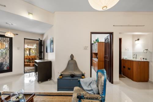 a living room with a couch and a chair at Gaia Homes in Bengaluru
