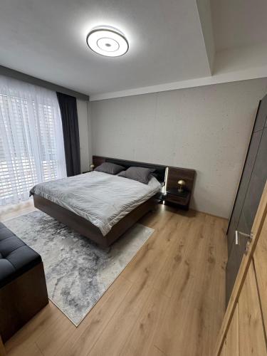 a bedroom with a bed and a large window at Apartmán Brezovina Lux in Veselé
